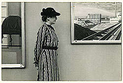Fig. 2: Edith Gregor Halpert (1900-1970) in front of a Charles Sheeler painting. She is wearing a dress made of fabric designed by Sheeler. Photograph by Charles Sheeler, detail. Courtesy of the Downtown Gallery Papers, Archives of American Art, Smithsonian Institution. A Premier Folk Art Museum Celebrates Fifty Years and a New Home by Carolyn J. Weekley