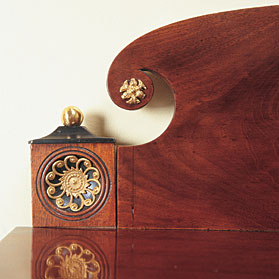 In this detailed image of the William Hook chest of drawers we can admire the maker's sense of restrained drama as illustrated by his use of ormolu ornamentation and contrasting woods.