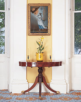 A nineteenth-century Chinese export reverse glass painting of the allegorical figure Liberty, Chinese school, after Edward Savage (1761-1817), hangs above a trick-leg table, circa 1810, attributed to New York cabinetmaker Michael Allison (1773-1855), a contemporary and neighbor of Duncan Phyfe (1768-1854), the most prominent cabinetmaker in New York in the early 1800s and one of the first to introduce the Empire style to the city.