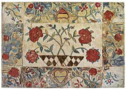 The exceptionally large nineteenth-century floral rug mounted on the side wall of the family room was purchased from Collette Donovan.