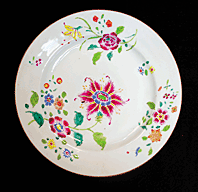 Fig. 11: Plate, Chinese export porcelain, Qing dynasty, Qianlong period (1736–1795). Part of a twelve-piece set originally associated with ownership by John Drayton in the mid-eighteenth century. Famille rose pattern. Overglazed polychrome floral designs with gilding. Flat plate with raised shoulder and cylindrical foot rim: Diam. 8-7/8 in.; foot rim diam. 4-7/8, H. 1 in. Donation of Anne Drayton Nelson. Courtesy, Drayton Hall, a historic site of the National Trust for Historic Preservation. Photography by Carter C. Hudgins. 