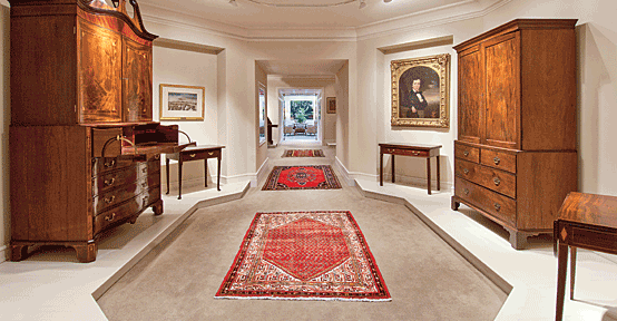 The Rivers Collection. Left: Charleston neoclassical serpentine press with secretary drawer, circa 1783–1790, with inlaid urns, bellflowers, and escutcheons; watercolor of the 17th Regiment of the South Carolina Militia, by A. Grinevald, 1861, hangs above a dressing table, with pad feet, Charleston, ca. 1740–1760. Right: Pembroke table, made and signed by Thomas Lee (active 1804–1813), Charleston; Linen press, Charleston, ca. 1775–1785; Mahogany and cypress gaming table, Charleston, ca. 1770–1785, over which hangs a portrait of a child, believed to be of Alexander Mazyck’s family, Charleston (whose mother’s and sibling’s portraits are also shown in the gallery), painted by Thomas Wightman, ca. 1850. Courtesy, the Rivers Collection, Charleston, S.C. Photography by Rick McKee. 