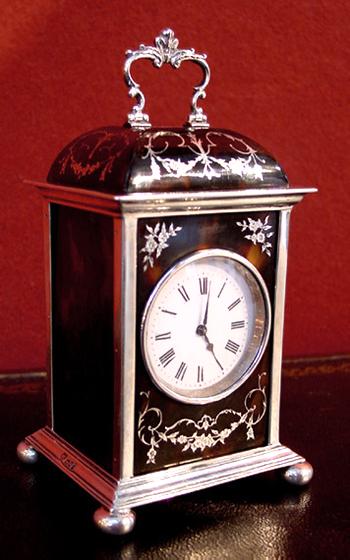 An English Edwardian tortoiseshell & silver clock