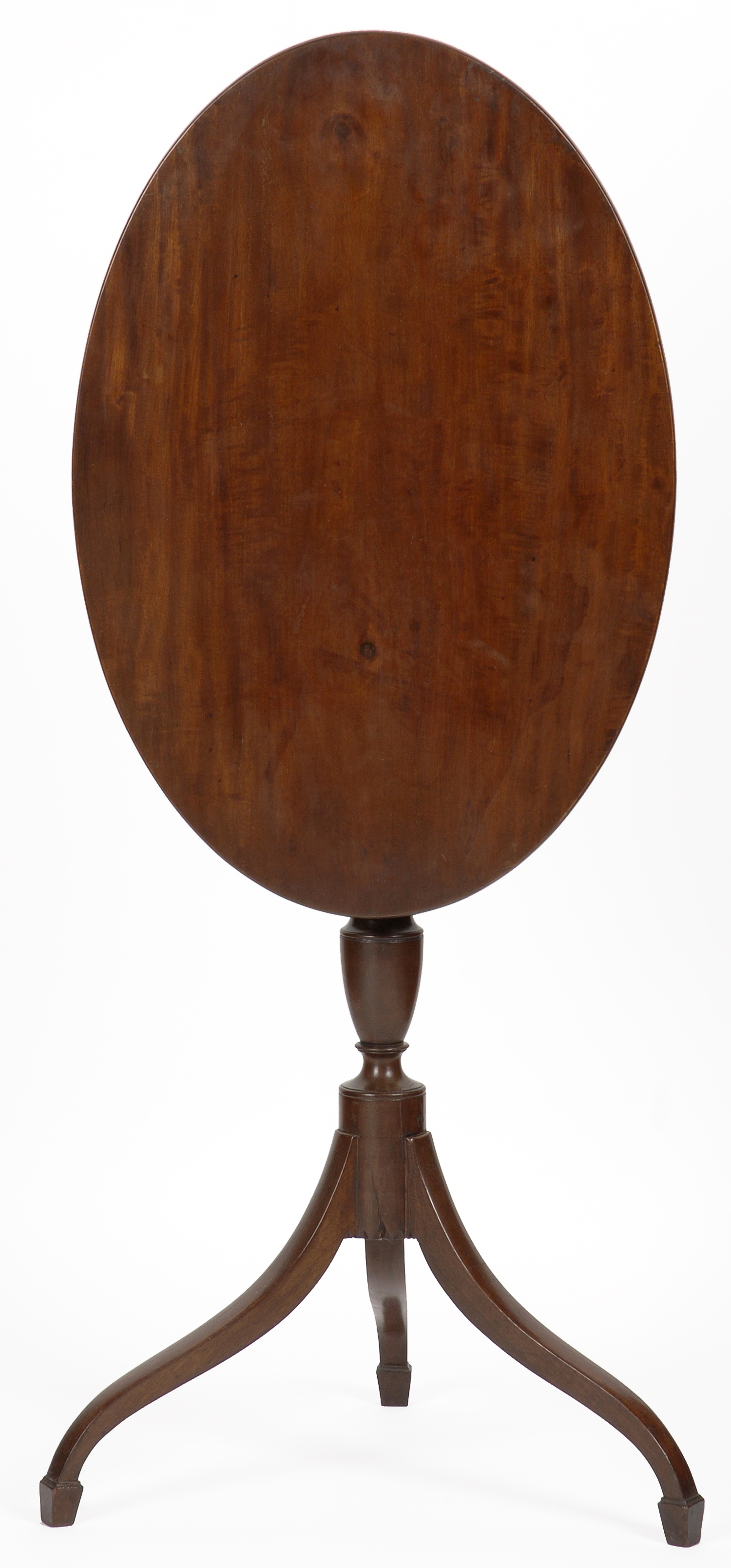 An attractive Hepplewhite mahogany oval tilt-top candle stand, probably Boston, circa 1790.